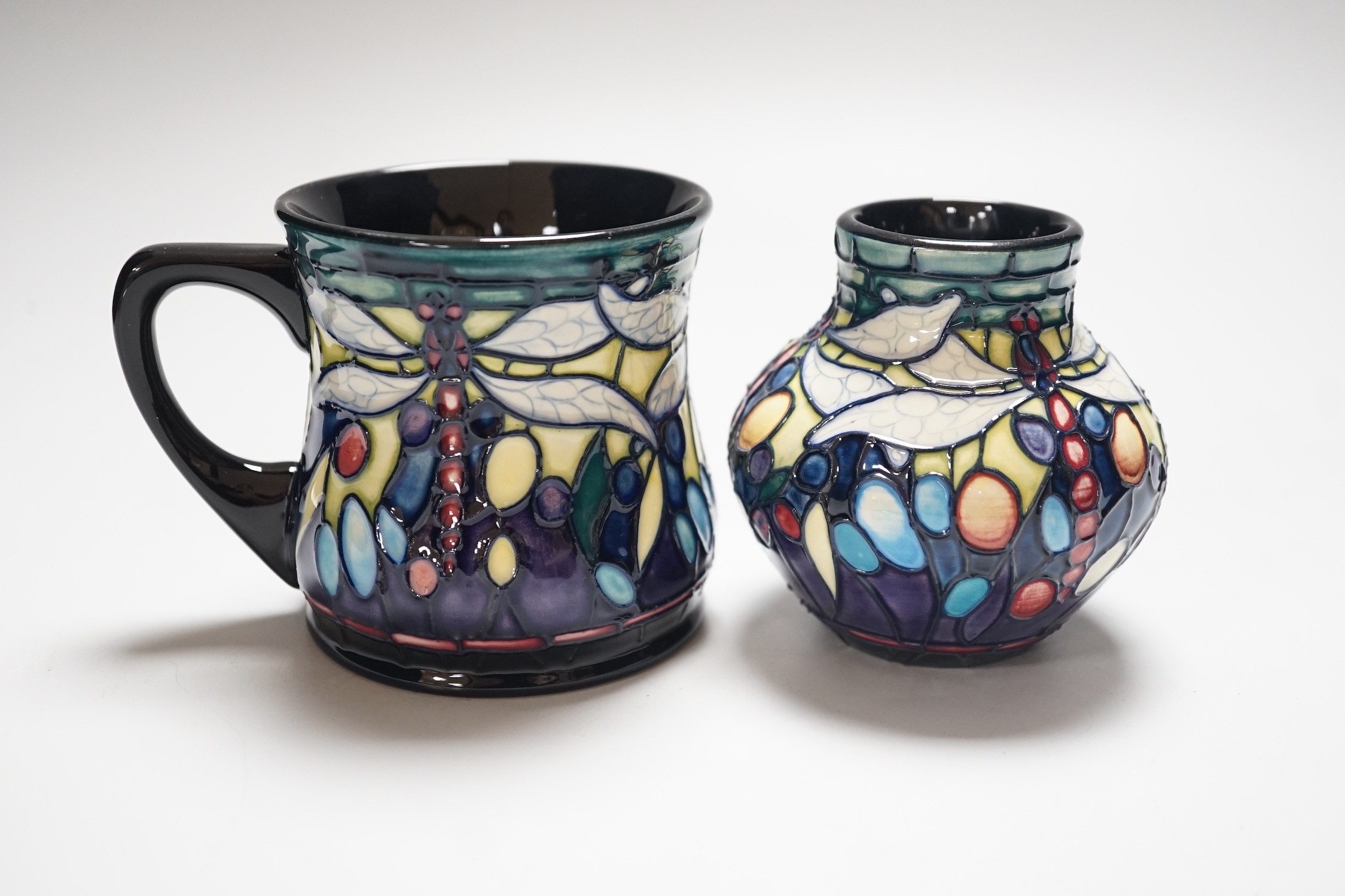 A boxed Moorcroft ‘Dragonfly’ mug and a similar vase, mug 8.5cms high